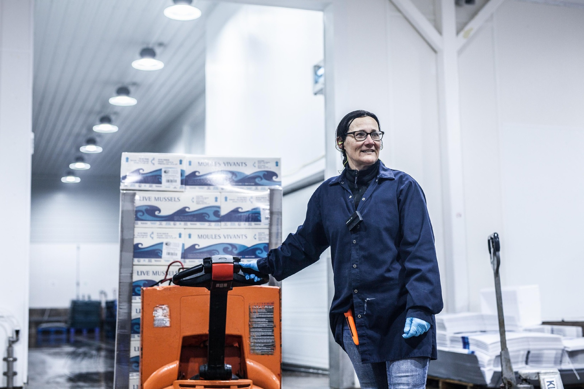 Warehouse worker with pallets of Canadian Cove mussels