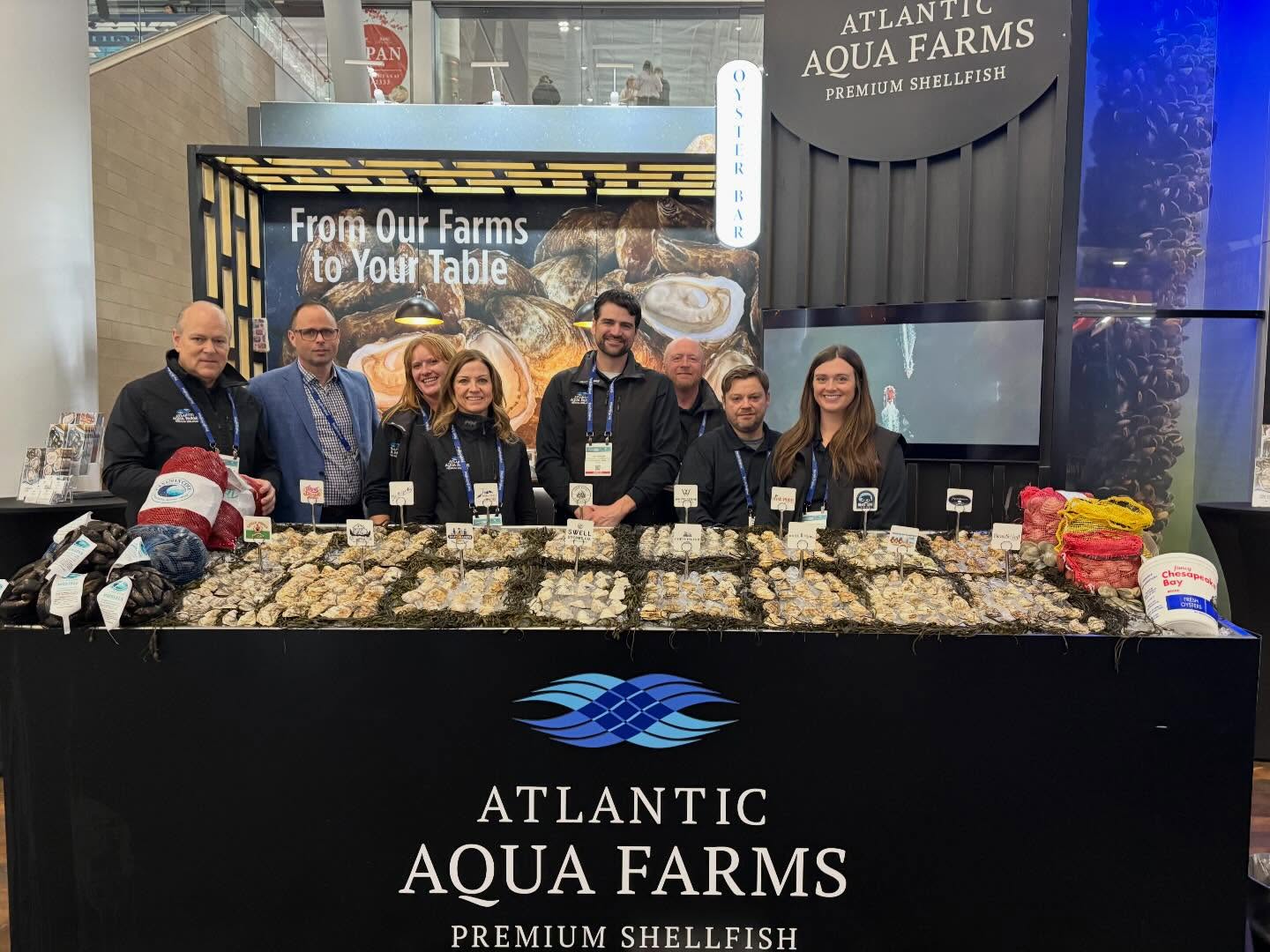 Atlantic Aqua Farms team at the oyster bar booth during a seafood expo